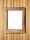 Blank wooden frame on bamboo wall