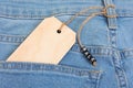 Blank wooden label tag and sale sign on jeans Royalty Free Stock Photo