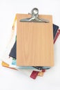 Blank wooden message board with pile of books Royalty Free Stock Photo