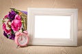 Blank wooden photo frame and pink alarm clock. Royalty Free Stock Photo