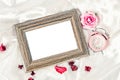 Blank wooden photo frame and pink alarm clock with rose. Royalty Free Stock Photo