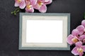 The blank wooden photo frame with pink color orchid on old black wooden background, Save clipping path. Flat lay Royalty Free Stock Photo