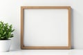 Blank wooden picture frame against white wall, wall, empty Royalty Free Stock Photo