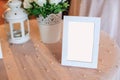 Blank wooden picture frame decoration on table decorated by white tablecloth. Wedding reception ceremony, anniversary celebration Royalty Free Stock Photo