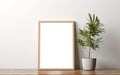 Blank wooden picture frame mockup on off white wall in modern interior. Vertical artwork template mock up for artwork, painting, Royalty Free Stock Photo