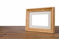 Blank wooden picture frame on table over white background Royalty Free Stock Photo