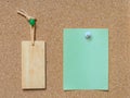 Blank wooden tag and paper on cork board Royalty Free Stock Photo