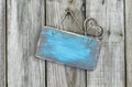 Blank worn sign with heart hanging on rustic fence
