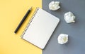 Blank writer notepad and crumpled paper on office desk Royalty Free Stock Photo