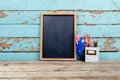 Blank writing slate by australian flag and desk organizer against wooden wall with copy space