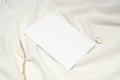 Blank 4x6 card, gold chain and ring on the white cloth Royalty Free Stock Photo