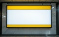 Blank yellow-bordered signboard mounted on a wall. Royalty Free Stock Photo