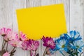 Blank yellow card with blue and pink daisies bunch of flowers
