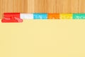 Blank yellow file tabs on wood desk background