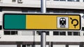 Blank yellow and green reflective road train station sign on the street