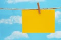 Blank yellow greeting card over sky