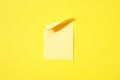 blank yellow note pad stick on vivid yellow background Royalty Free Stock Photo