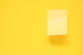 blank yellow note pad stick on vivid yellow background Royalty Free Stock Photo
