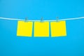 Blank yellow paper notes on clothesline Royalty Free Stock Photo