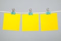 Blank yellow paper notes hanging on clothesline Royalty Free Stock Photo