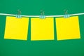 Blank yellow paper notes hanging on clothesline Royalty Free Stock Photo