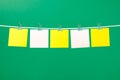 Blank yellow and pink paper notes on the string Royalty Free Stock Photo