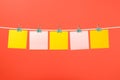 Blank yellow and pink paper notes on the string Royalty Free Stock Photo