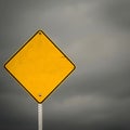 blank yellow road sign infront of cloudy gray sky Royalty Free Stock Photo