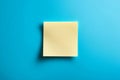 Blank yellow sticky note on blue background providing copy space for important messages or reminders Royalty Free Stock Photo