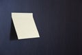 Blank Yellow Sticky Note stuck on the black wooden Royalty Free Stock Photo