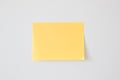 Blank Yellow Sticky Note on the White Wall Royalty Free Stock Photo