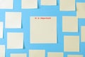 Blank yellow sticky notes on a blue background, concept of business work. Yellow memo stickers on blue wall. Mock-up. The
