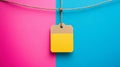 Blank Yellow Tag Hanging on Pink and Blue Background Royalty Free Stock Photo