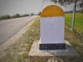 A blank yellow and white color milestone on the international highway