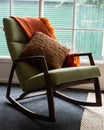 Blanket and cushion on green rocking chair Royalty Free Stock Photo