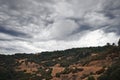 Dramatic Thunder Clouds over a Winding Mountain Road