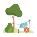 Blanket is dried on a rope near a tree. Vector illustration.