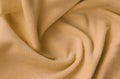 The blanket of furry orange fleece fabric. A background of light orange soft plush fleece material with a lot of relief folds Royalty Free Stock Photo