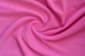 The blanket of furry pink fleece fabric. A background of light pink soft plush fleece material with a lot of relief fold