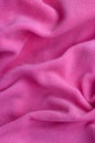 The blanket of furry pink fleece fabric. A background of light pink soft plush fleece material with a lot of relief folds Royalty Free Stock Photo