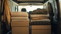 Blankets and cardboard boxes loaded in the back of a van, prepared for donation or relocation Royalty Free Stock Photo