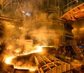Blast furnace iron tapping. Hot steel is poured into another pan Royalty Free Stock Photo