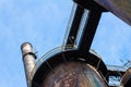 Blast furnaces and smokestack ringed with walkways as part of an abandoned old industrial steel mill site, viewed from below, blue Royalty Free Stock Photo