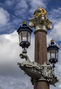 Blauwbrug Blue Bridge in Amsterdam. columns decorated with lanterns. The tops of the columns are crowned with the crowns of the Au Royalty Free Stock Photo