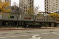 Blaze Pizza and Five Guys downtown with yellow autumn trees, people walking, office buildings and fallen autumn leaves Royalty Free Stock Photo