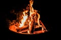 Blazing bonfire lit up against a night sky Royalty Free Stock Photo