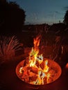 Blazing fire in fireplace with evening sky Royalty Free Stock Photo