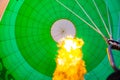 Hot air balloon, view inside with flame. Blowing up the balloon. Royalty Free Stock Photo