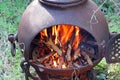 Blazing wood fire outside in a chiminea. Royalty Free Stock Photo