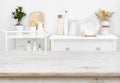 Bleached tabletop with copyspace over blurred kitchen furniture with tools